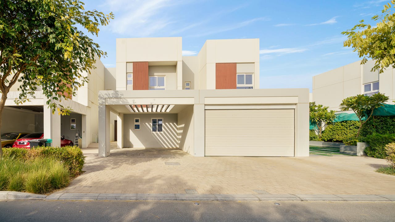 Contemporary villa exterior showcasing modern architecture set in a serene neighborhood.
